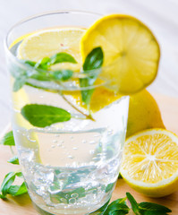 Glasss of mojito with lemon and drinking straw