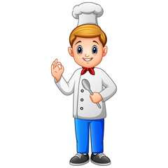 Young chef man in uniform holding a spoon isolated on white background