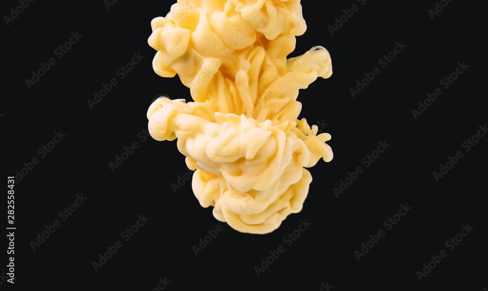 Poster yellow-white acrylic cloud moving in liquid, isolated on black background, close up view. drop of in
