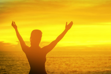 strong confidence woman open arms under the sunrise at seaside