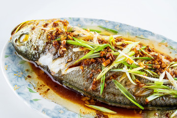 Chinese national dish steamed flower yellow croaker on white background