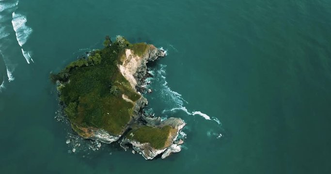 The large island at Ruby Beach being filmed with a drone during sunset.