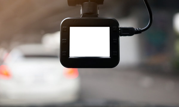 Dash Camera with white blank screen monitor with blurry background.