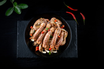 Mantis shrimp in pepper and salt shrimps in the black background