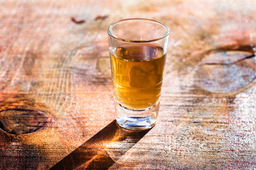 Several glasses of brazilian cachaça isolated on rustic wooden background, variations and types of brazil cachaça, typical drink from brazil.