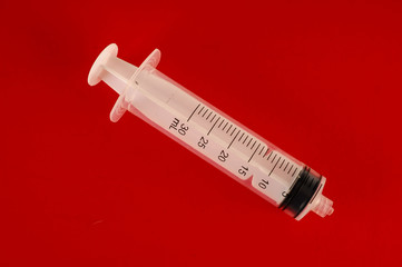 Syringe closeup isolated on colred background