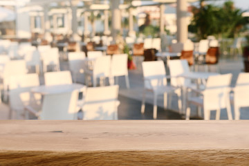 background Image of wooden table in front of blurred restaurant