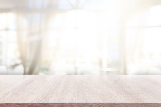 background of wooden table in front of abstract blurred window light