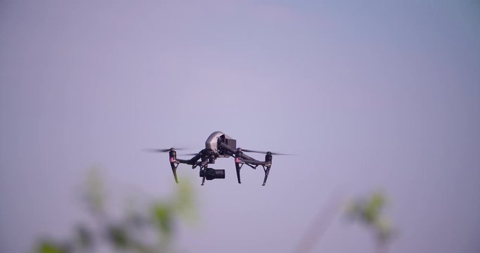 Drone flying and filming in clear blue sky 4K video