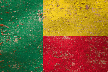 National flag of Benin on old peeling wall background.The concept of national pride and symbol of...