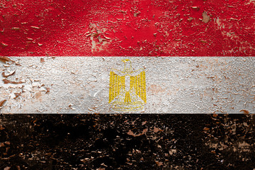 National flag of Egypt  on old peeling wall background.The concept of national pride and symbol of...