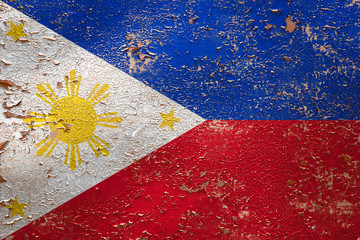 National flag of Philippines on old peeling wall background.The concept of national pride and...