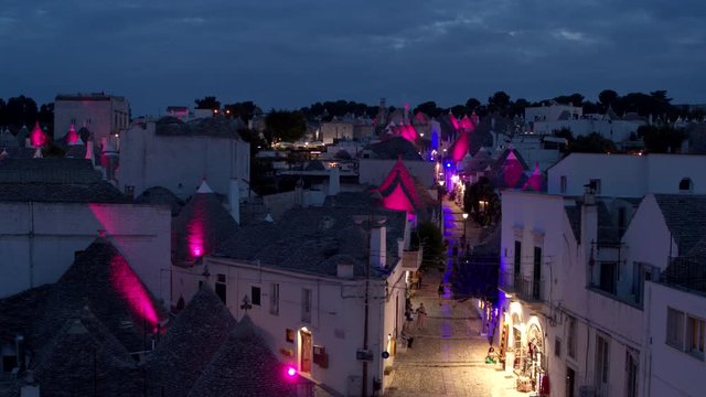Drone shot of the Vivid lights in the small town of Alberobello, Italy