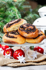 Poppy seed buns on cake stand. Christmas eve setting