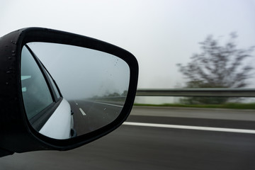 Car on the road with mirror reflection. Motion blur road.