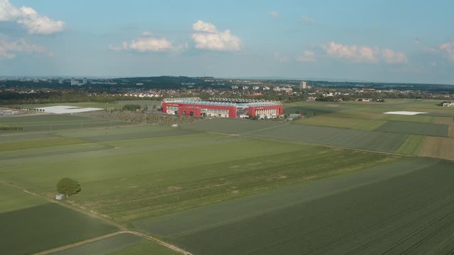Drone / Aerial shot of the football stadium of the bundesliga team FSV Mainz 05 with field in the foreground on a sunny day, 30p