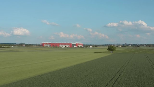 Drone / Aerial shot of the football stadium of the bundesliga team FSV Mainz 05 with field in the foreground on a sunny day, 25p