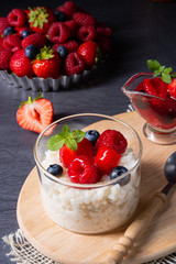delicious milk rice with different berries and red fruit jelly