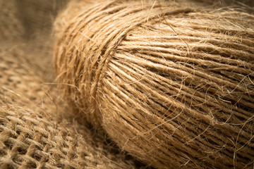 Close up wrapped linen rope isolated on burlap
