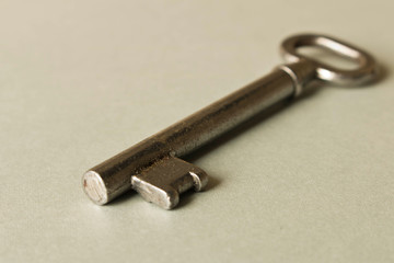 Old key on grey background. Key isolated on grey background.