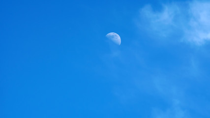 moon on a blue sky day