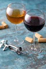Glasses of white and red wine. The concept of winemaking. Place under your text. Still life on a textural background.