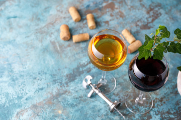 Glasses of white and red wine. The concept of winemaking. Place under your text. Still life on a textural background.