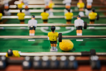 Table football, table football with close-ups of yellow and white players.