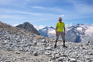 Fototapeta premium Senior man hiking in Dolomites with beautiful mountains in the background