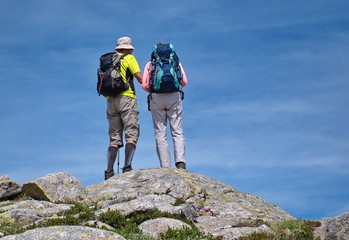 Fototapeta premium Low angle view of senior couple hiking in Dolomites