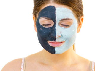 Girl with black white mud mask on face
