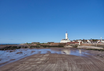 Looking over the small Beach adjacent to Arbroath Harbour south to the Signal Tower Museum one early Summers morning in May. Arbroath, Angus, Scotland.