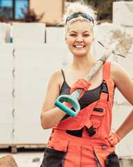 Woman using shovel on constriction site