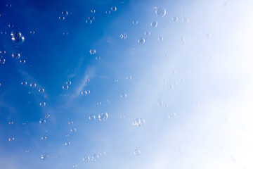 Soap bubbles fly in the blue sky