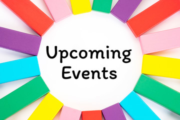 Upcoming Events written on a white paper with a colorful wooden blocks toys to remind you and...