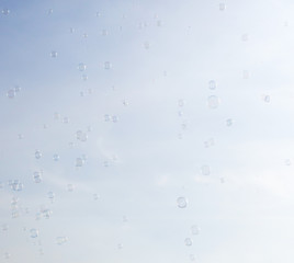 Soap bubbles fly in the blue sky