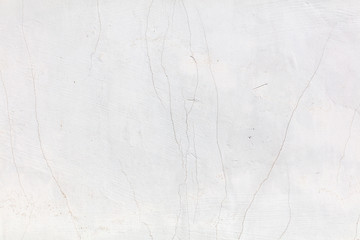 White wall with cracked plaster as abstract background