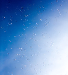 Soap bubbles fly in the blue sky