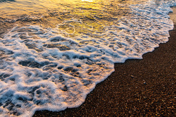 Waves on the seashore at sunset