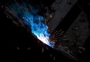 Sparks from welding at a construction site as a background