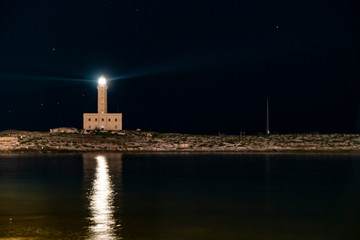 Lighthouse at night, double light. Viste, Italy