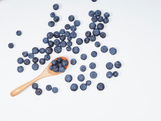 Blueberry fruit vitamins in a wooden spoon