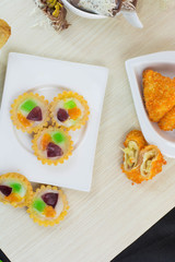 Jajanan pasar pie buah or fruit pie and risoles on white plate