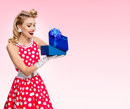 woman in pin-up style dress with gift box