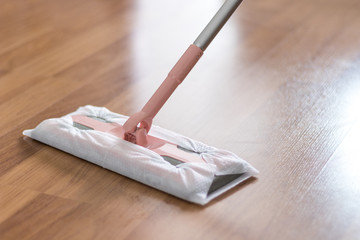 Wooden laminate floor cleaning with mop, home maintenance