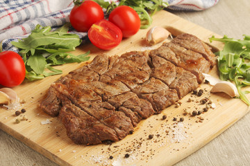A beef steak well done with vegetables	