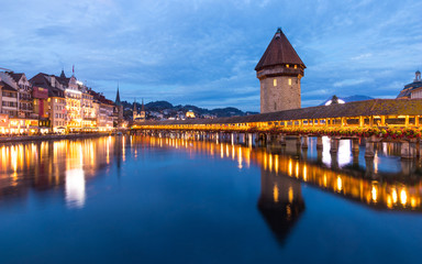 Fototapeta na wymiar Old wooden architecture called Chapel Bridge in Luzern or Lucerne, Switzerland during sunset and twilight