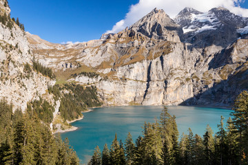 Oeschinensee lake in Kandersteg, Switzerland. Nature background with mountain and water