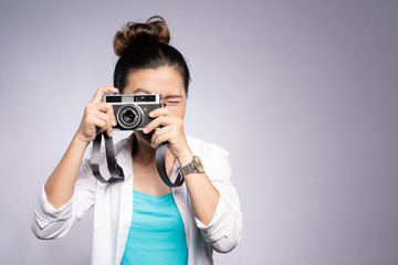 Happy woman take a photo by camera isolated over background