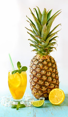 Yellow iced tea with lemon, pineapple